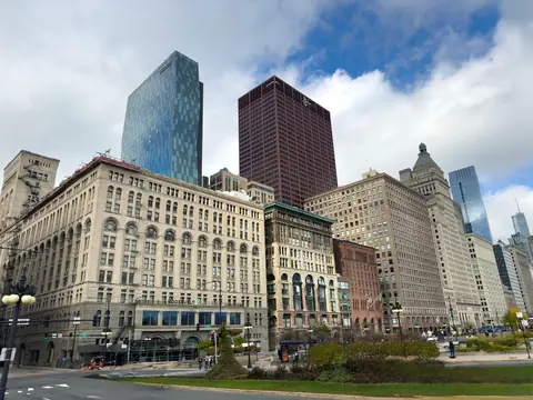 Historic and modern Chicago buildings under a bright sky