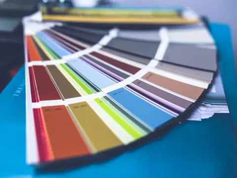A fan of color swatches spread out on a blue folder
