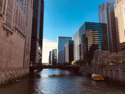 The Chicago River between tall buildings on a sunny day