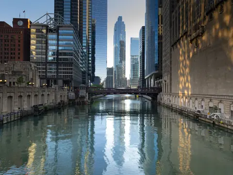 The Chicago River running between towers, the skyline reflected in the water