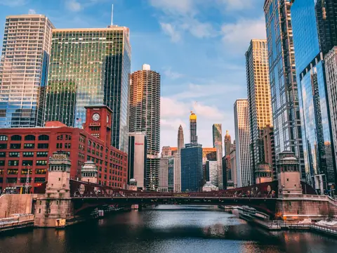 Chicago towers and a river bridge in warm evening light
